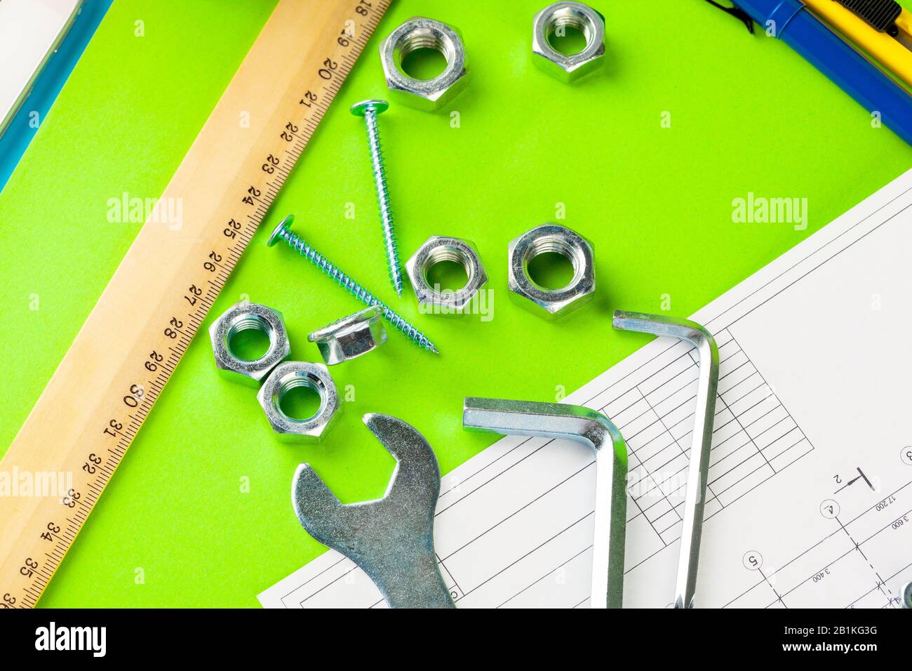 tecnologia e lavorazione dei metalli. Bullone e dado in metallo sullo  sfondo dei disegni stampati Foto stock - Alamy