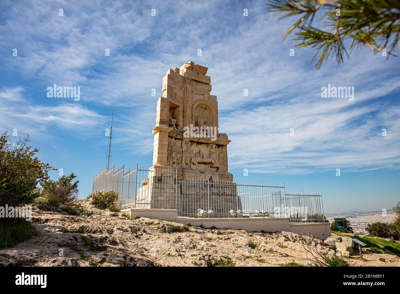 Philopappos Monumento vista ad angolo basso, cielo blu sfondo. Il Monumento a Filopappos è un antico mausoleo greco situato sulla collina di Mouseion ad Atene, Grecia Foto Stock