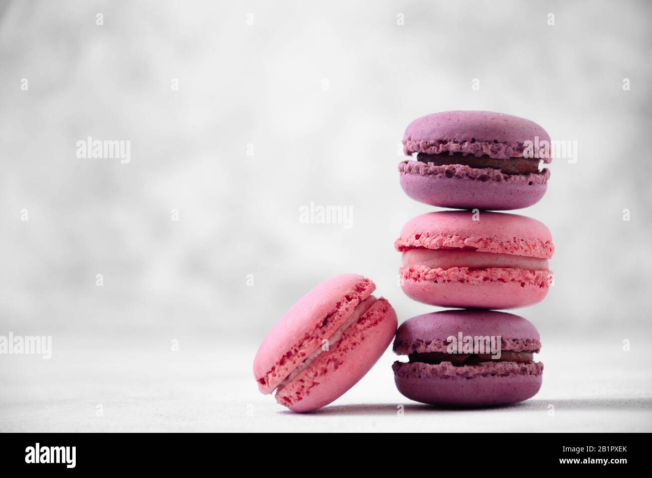 Macaron Rosa E Viola Francesi Su Sfondo Grigio Chiaro. Foto Stock