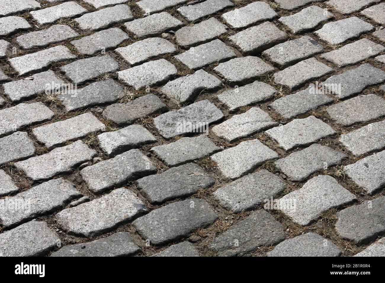 Astratto sfondo acciottolato. Ciottoli di granito. Vecchia superficie stradale. Foto Stock