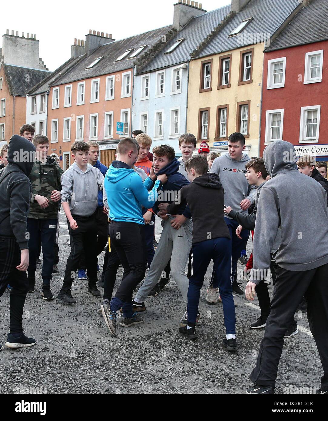 I ragazzi si sono inchiditi per la palla di pelle durante l'annuale evento di gioco di Jedburgh ba' sulla High Street di Jedburgh ai Confini scozzesi. Data Immagine: Giovedì 27 Febbraio 2020. L'evento annuale è iniziato nella 1700s e il primo gioco mai è stato presumibilmente giocato con la testa di un inglese. Si tratta di due squadre, Uppies (residenti dalla parte superiore di Jedburgh) e le Doonies (residenti dalla parte inferiore di Jedburgh) ottenere la palla o la parte superiore o inferiore della città. La palla, realizzata in pelle, ripiena di paglia e decorata con nastri che rappresentano i capelli, viene gettata nel corvo Foto Stock