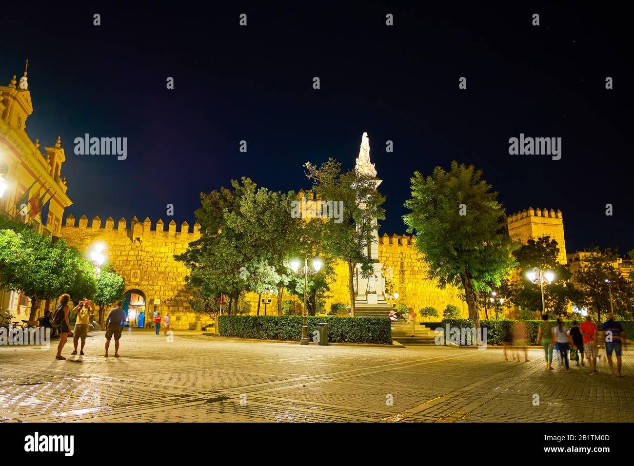 Siviglia, SPAGNA - 1 OTTOBRE 2019: Le persone camminano per il quartiere storico di notte godendosi l'illuminazione luminosa dei monumenti medievali, il 1° ottobre di Foto Stock