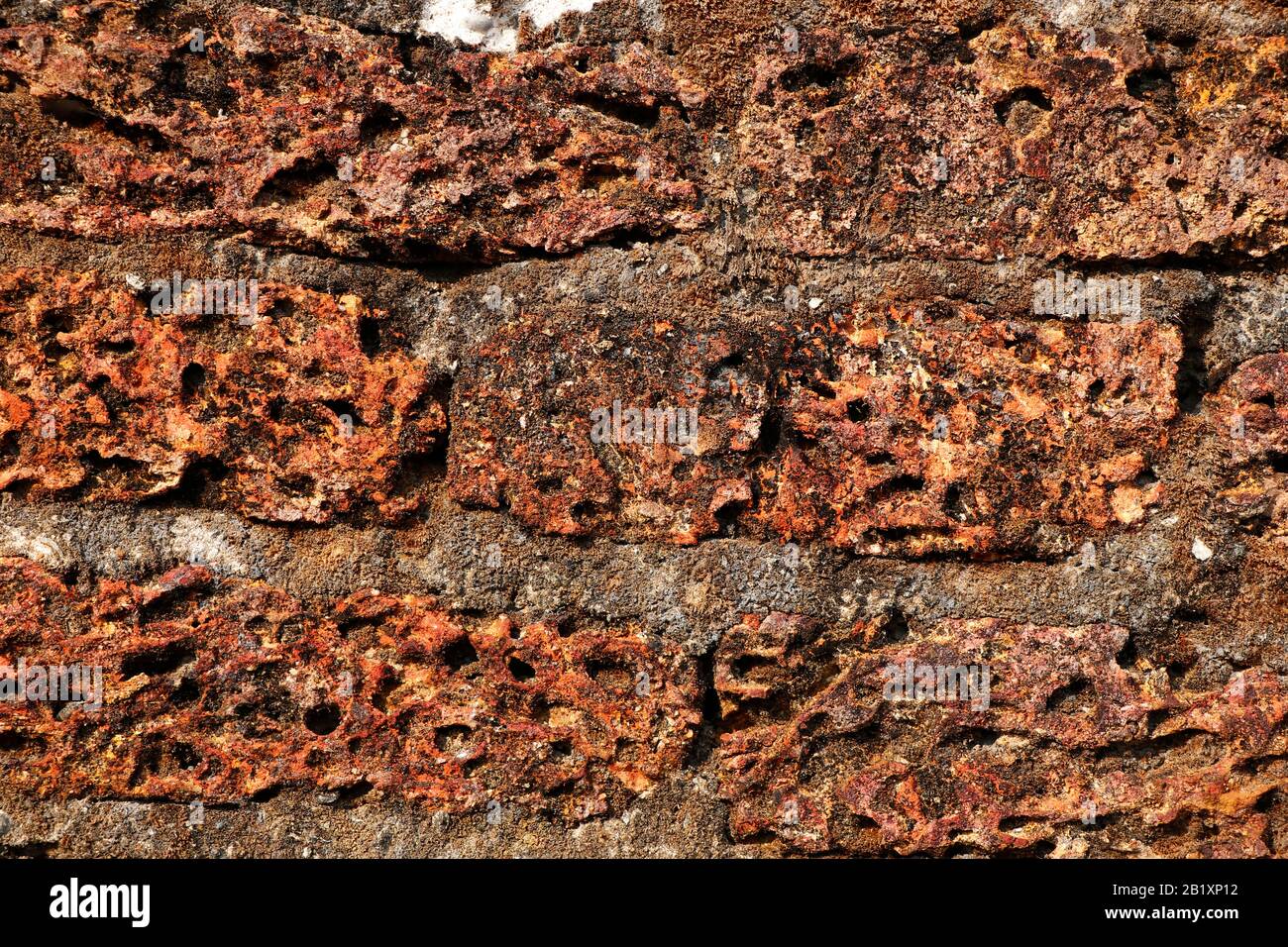 Foto sfondo texture da laterite muro di mattoni. Foto Stock