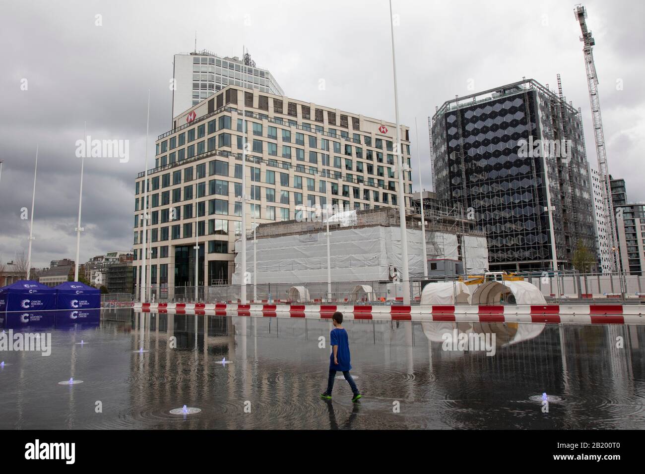 Persone locali che interagiscono con le nuove fontane in Centenary Square a Birmingham, Regno Unito. Il 16m £di sviluppo della piazza del Centenario Birminghams è stato aperto formalmente. Paradise, precedentemente chiamato Paradise Circus, è il nome dato ad una superficie di circa 7 ettari nel centro della città di Birmingham tra Chamberlain e Le Piazze del Centenario. La zona è stata parte del centro civico di Birmingham dal 19th secolo. Dal 2015 Argent Group svilupperà nuovamente l'area in nuovi edifici ad uso misto e piazze pubbliche. Foto Stock