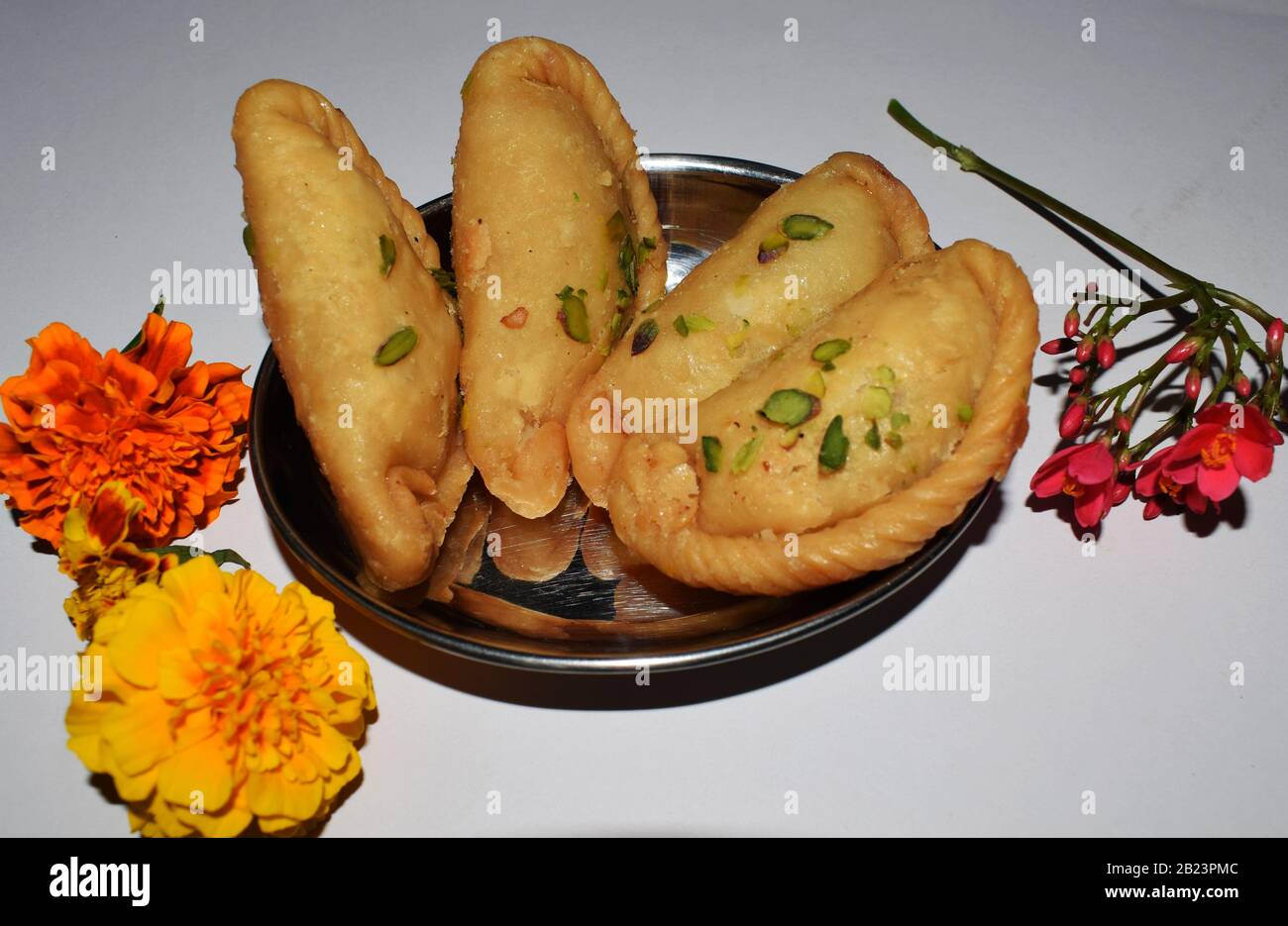 Gustoso piatto indiano dolce Chandrakala significato Mezza luna è fritto profondo Dumpling mangiato durante il festival Holi Foto Stock