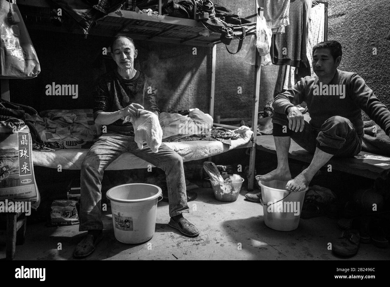 Scena di strada in un quartiere della città vecchia di Chongqing. Operai edili nel loro alloggio, Chongqing, Cina Foto Stock