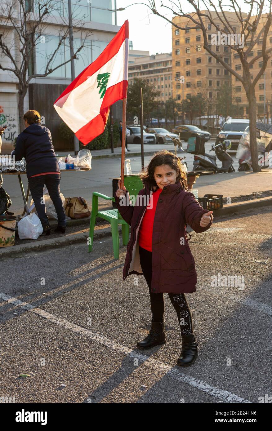 Manifestazione di Beirut 29th Febbraio 2020, Piazza dei Martiri : giovane dimostratore con bandiera libanese su Piazza dei Martiri Foto Stock