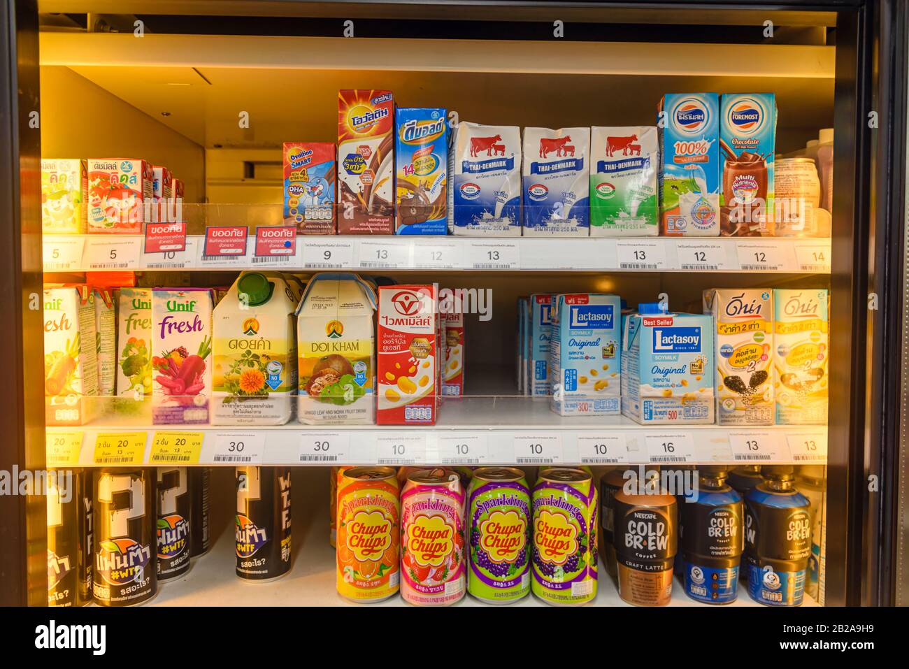 Frigorifero con bevande fredde, tra cui latte senza lattosio, Chupa Chups e  caffè freddo in un supermercato in Thailandia Foto stock - Alamy