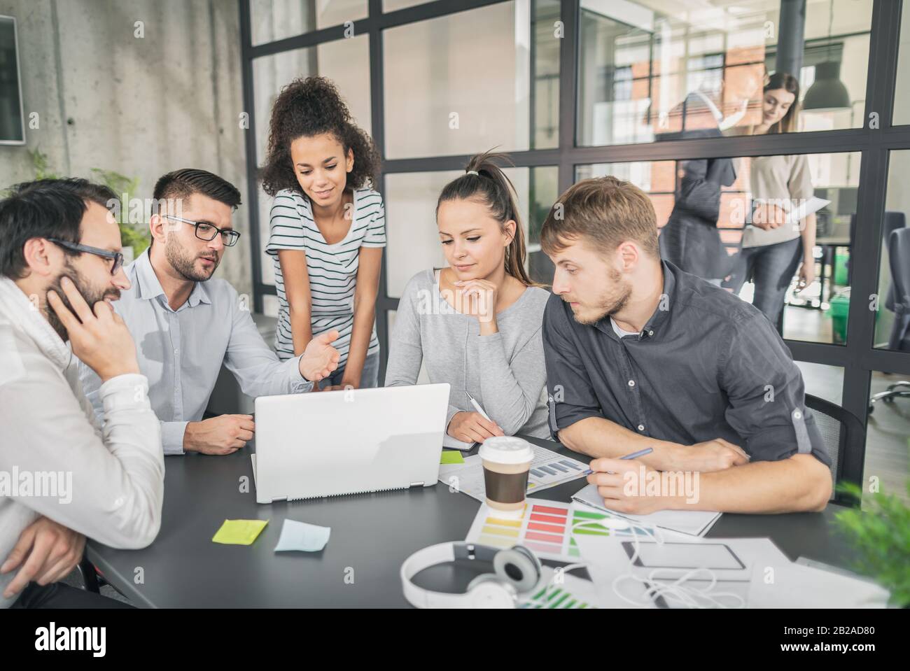 I giovani uomini di affari riunione in ufficio e discutendo insieme un nuovo progetto di avvio. Foto Stock