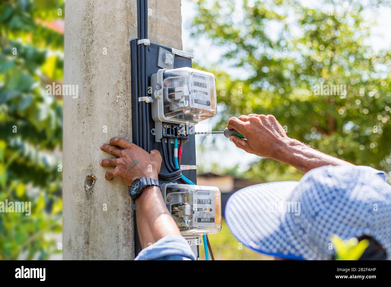 Tecnico che installa il contatore elettrico sul polo per misurare il watt  in casa Foto stock - Alamy