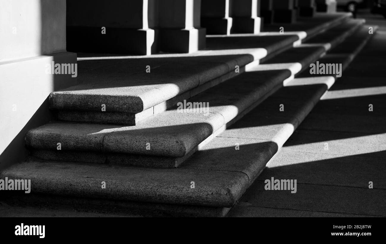 Luci e ombre sui gradini dell'edificio Foto Stock