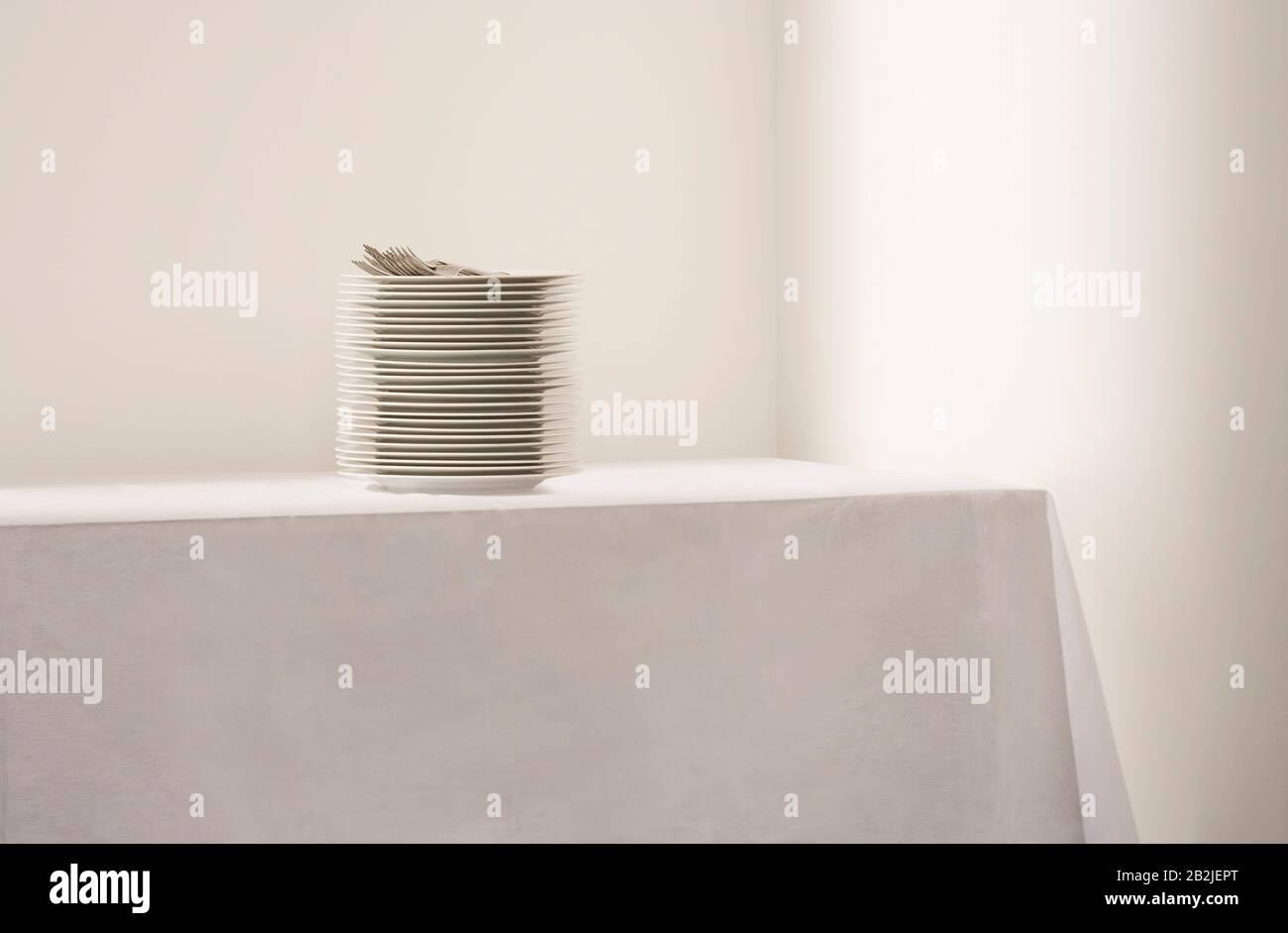 Pila di piatti e posate sul tavolo Foto Stock