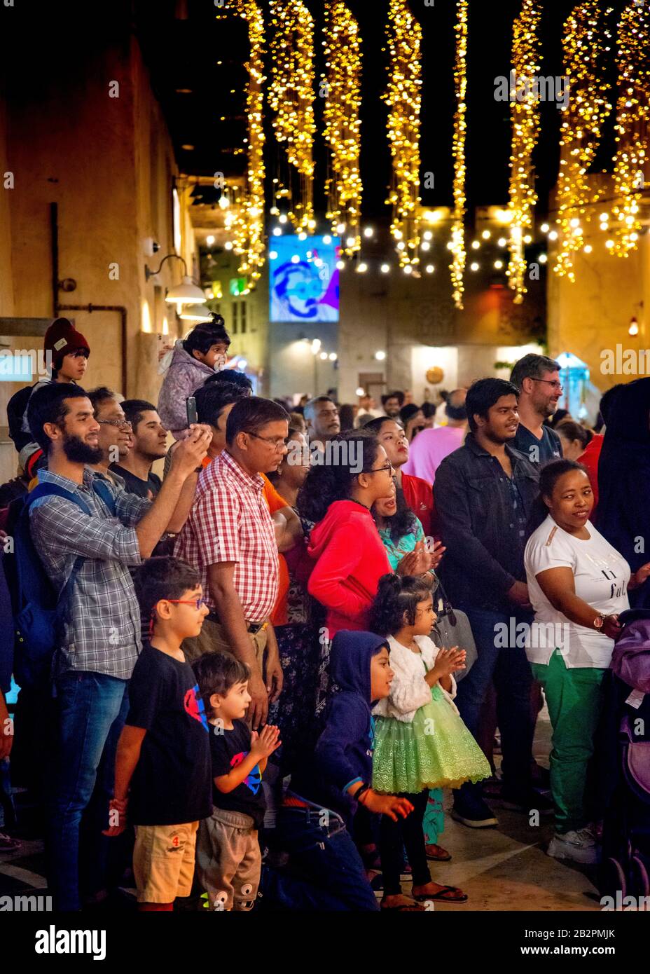 Gruppo di persone che guardano tutti nella stessa direzione, nel centro storico,Dubai, Foto Stock