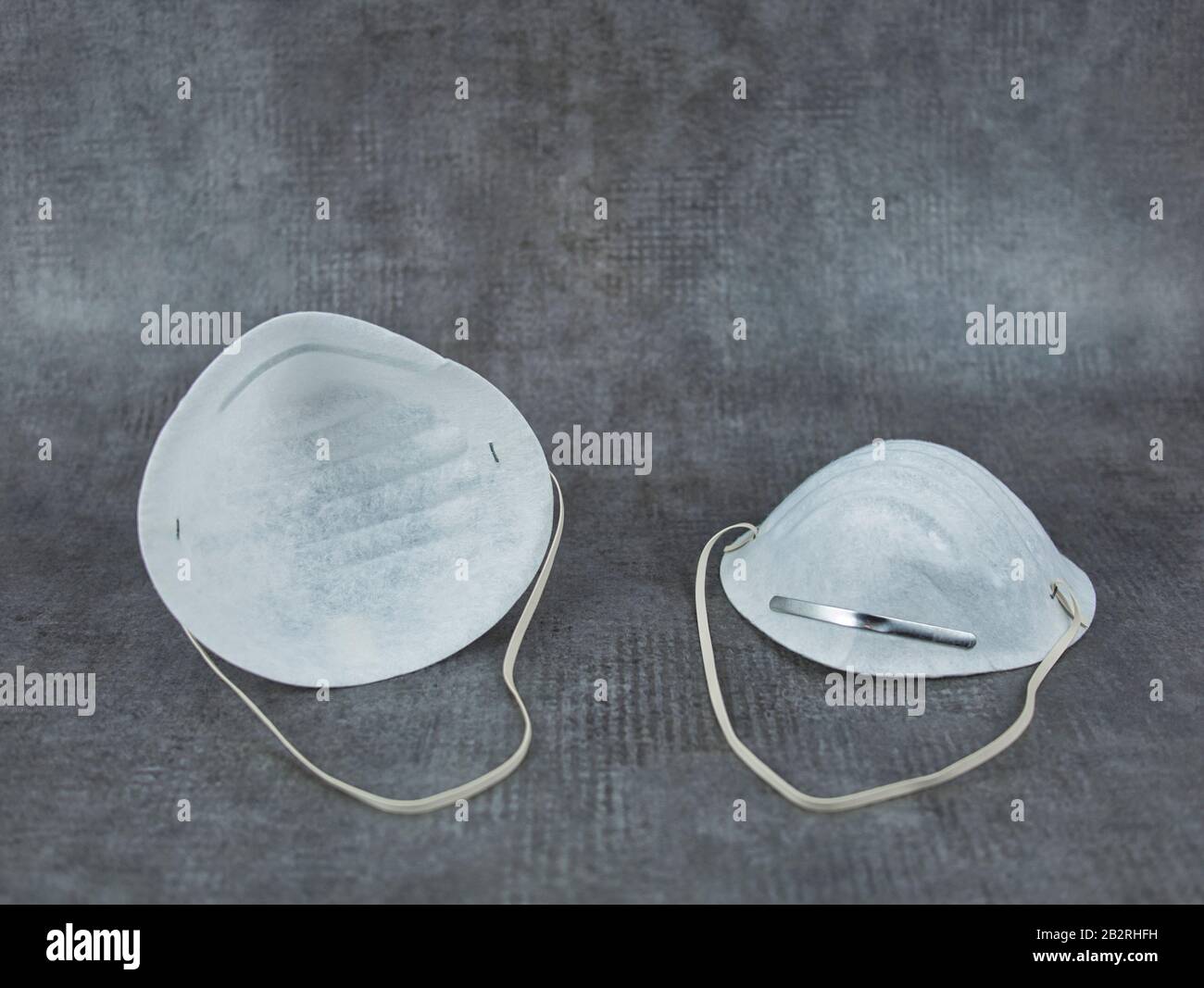 Due maschere facciali con stanghette metalliche per naso e fasce elastiche Foto Stock