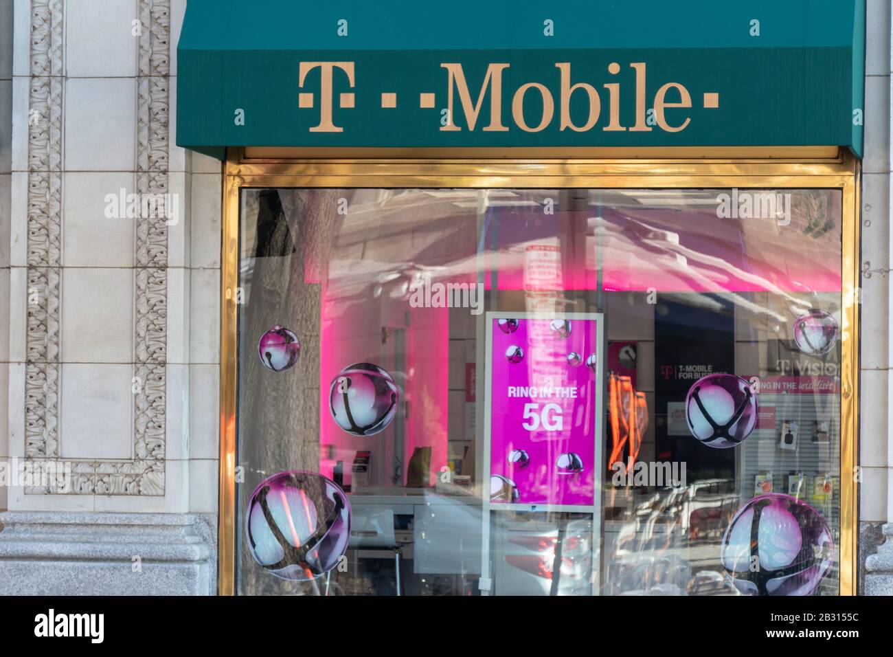 T-Mobile storefront con cartello per la nuova rete 5G nella vetrina. Foto Stock