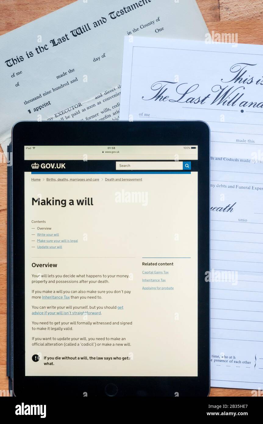 Consigli governativi sulla creazione di un verrà visualizzato su un computer tablet ipad insieme a un paio di moduli prestampati. Foto Stock