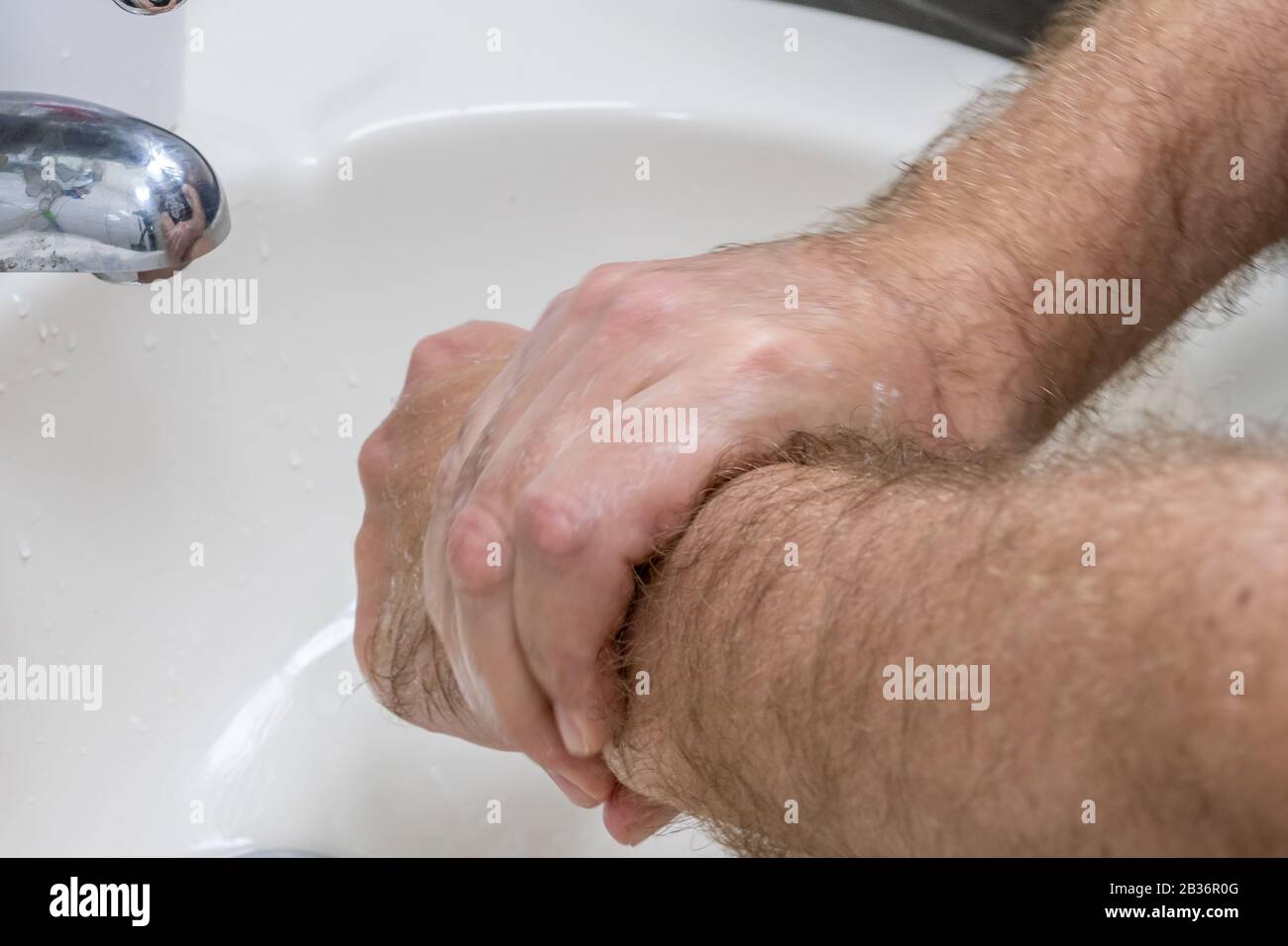 Uomo lavando le mani in primo piano lavabo, uno di diversi in serie handwashing steps Foto Stock