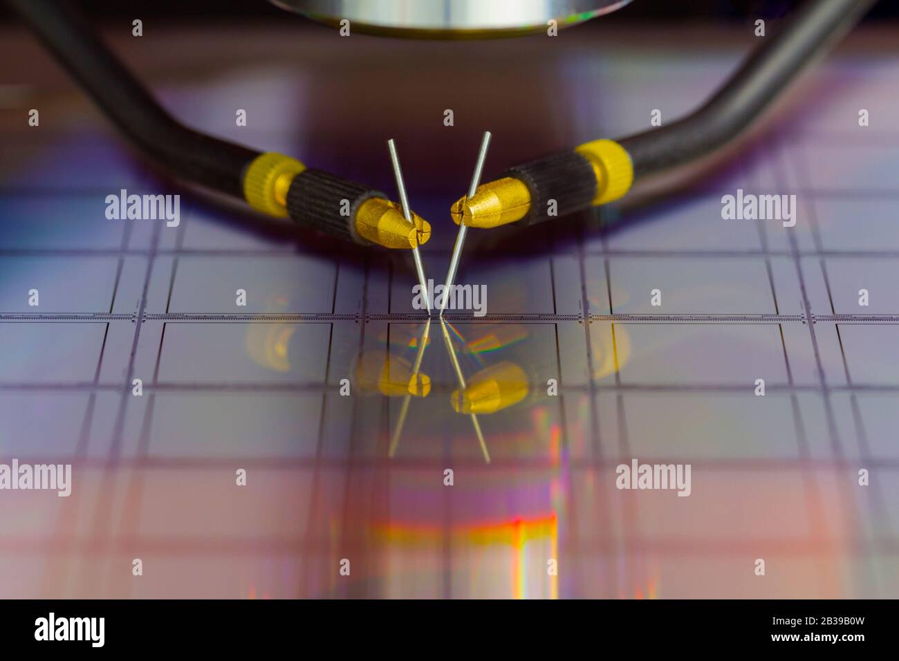 Primo piano dell'esame di un campione di transistor a microchip con Stazione di sonda sotto il microscopio in laboratorio.A semiconduttore su a. wafer di silicio Foto Stock