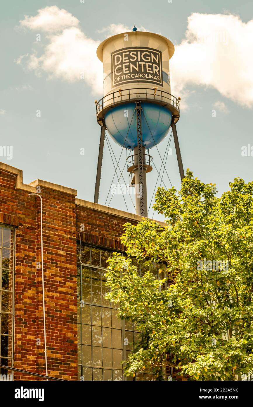 Charlotte, NC/USA - 14 maggio 2019: Medium shot guardando in alto la torre d'acqua vintage con fondo blu nel South End con la grafica "Design Center" contro un blu Foto Stock