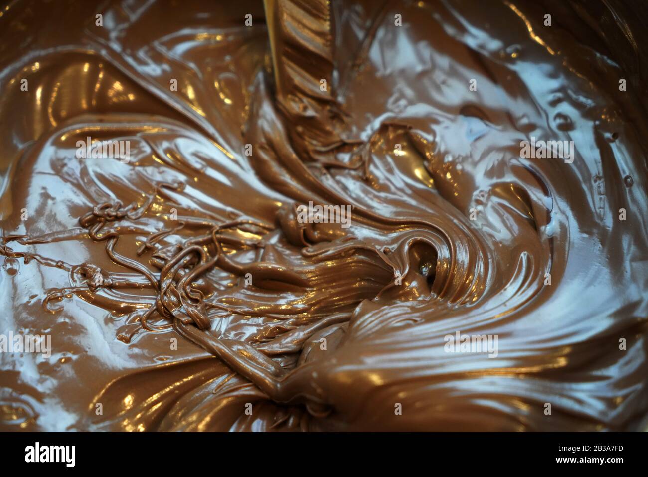 Sfondo con spirale di cioccolato fuso disegnato dall'alto Foto Stock