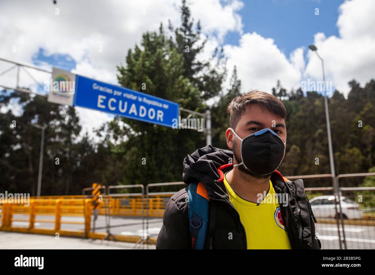 04 marzo 2020, Ecuador, Tulcán: Un giovane colombiano con un proteggi bocca attraversa il confine dalla Colombia all'Ecuador. Come misura precauzionale contro la diffusione del nuovo coronavirus, il Ministero della Salute ecuadoriano sta conducendo controlli sanitari al confine con la Colombia. Foto: Juan Diego Montenegro/Dpa Foto Stock