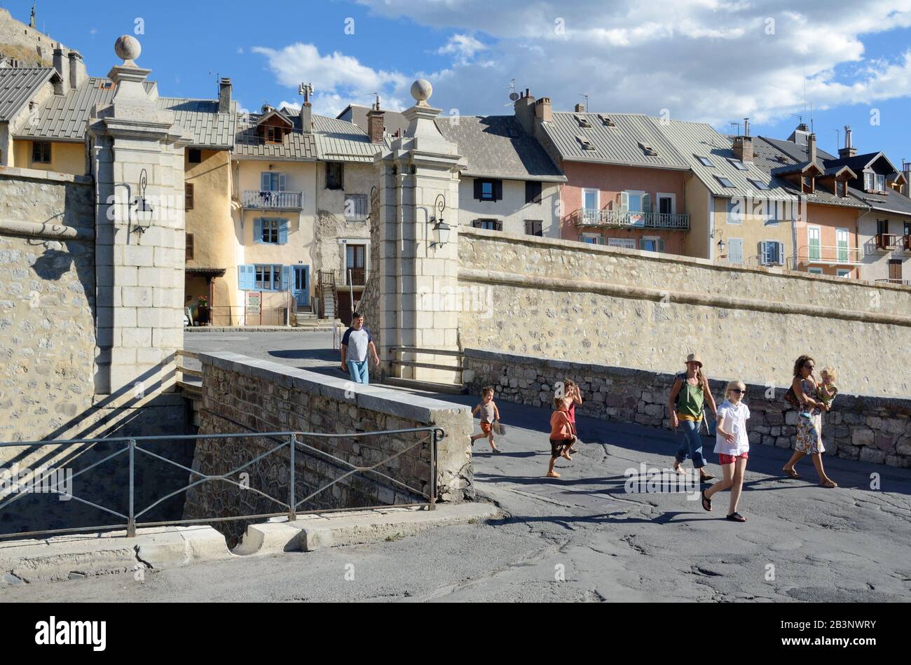 Turisti in famiglia di fronte alla Porte Dauphine nella città fortificata di Vauban Briançon, Hautes-Alpes, Francia Foto Stock