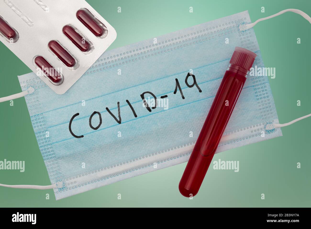 Concetto di test del sangue per coronavirus. Vista dall'alto con pillole, provetta con sangue del paziente e maschera respiratoria. Focolaio del virus Wuhan cinese. 2019-nCoV (COVID Foto Stock