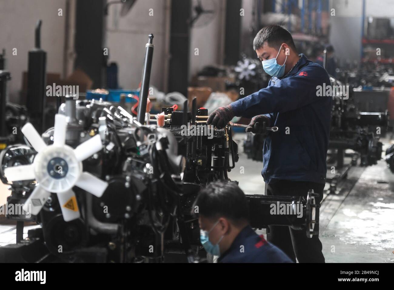 (200306) -- NINGBO, 6 marzo 2020 (Xinhua) -- Persone lavorano in un workshop di Zhetuo Benye (Ningbo) Tractor Manufacturing Co., Ltd. Nel distretto di Fenghua di Ningbo City, nella provincia di Zhejiang della Cina orientale, 6 marzo 2020. I lavoratori di Zhetuo Benye (Ningbo) Tractor Manufacturing Co., Ltd. Operano in officina da quando l'azienda ha ripreso la produzione il 10 febbraio, aumentando la produzione per soddisfare la domanda degli ordini e garantire la preparazione dell'aratura della molla. (Xinhua/Huang Zongzhi) Foto Stock