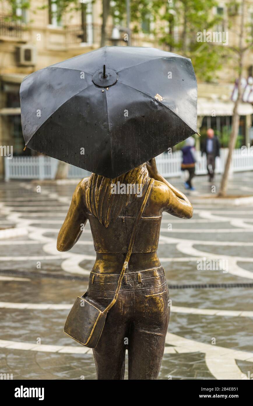 Azerbaigian, Baku, Piazza Fontana, scultura di ragazza con ombrello e telefono cellulare, senza uscite Foto Stock