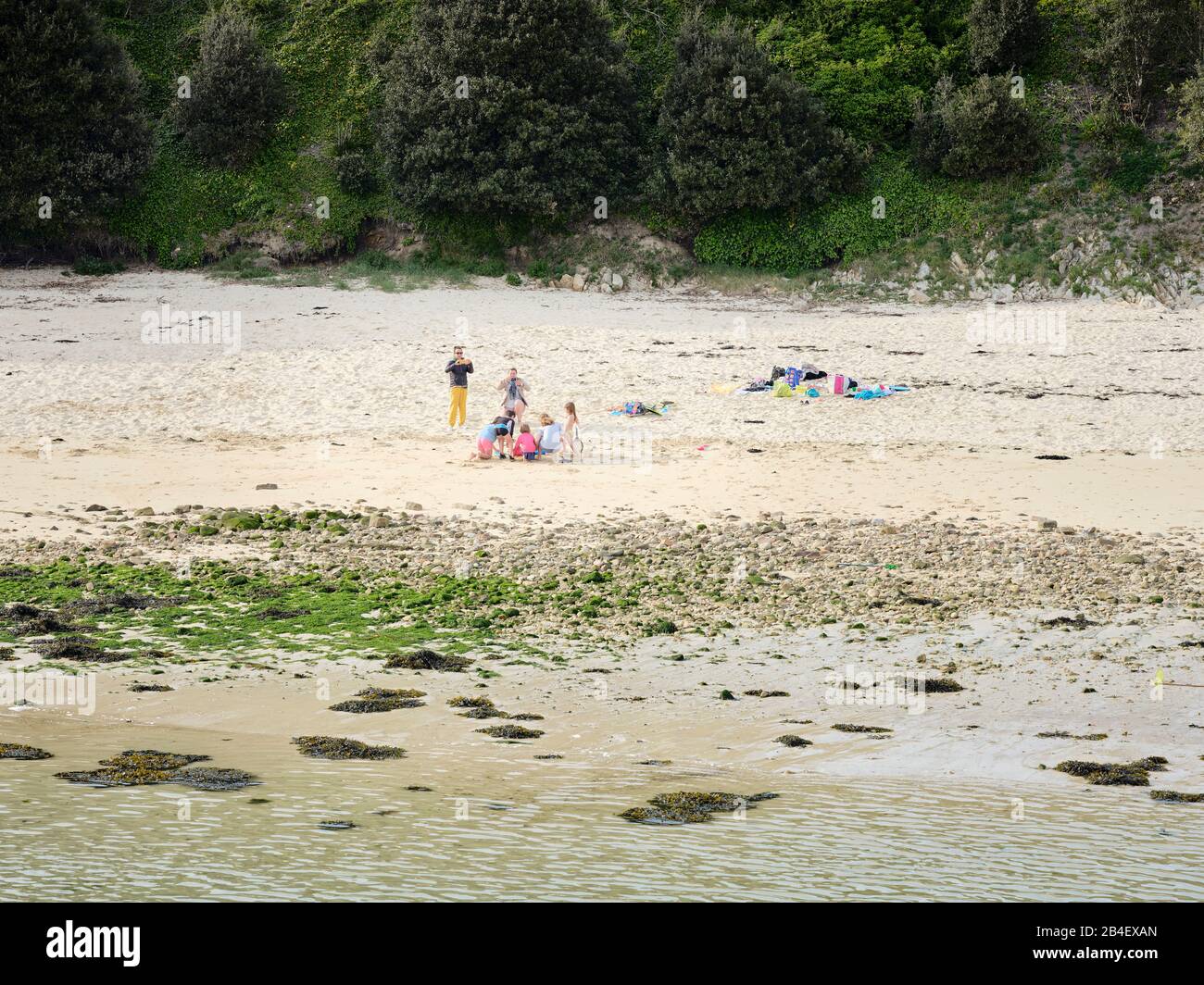 Ein Familiennachmittag am Strand von Capusins a Audierne in der Bretagne. Die Kinder positeren für ein Erinnerungsfoto. Foto Stock