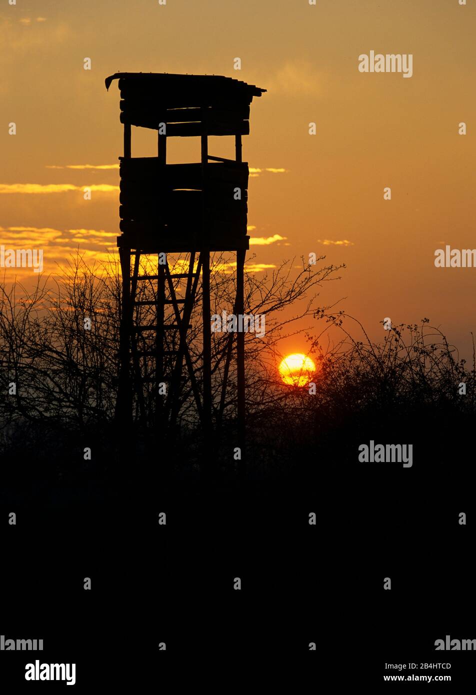 Posto a sedere alto al tramonto Foto Stock