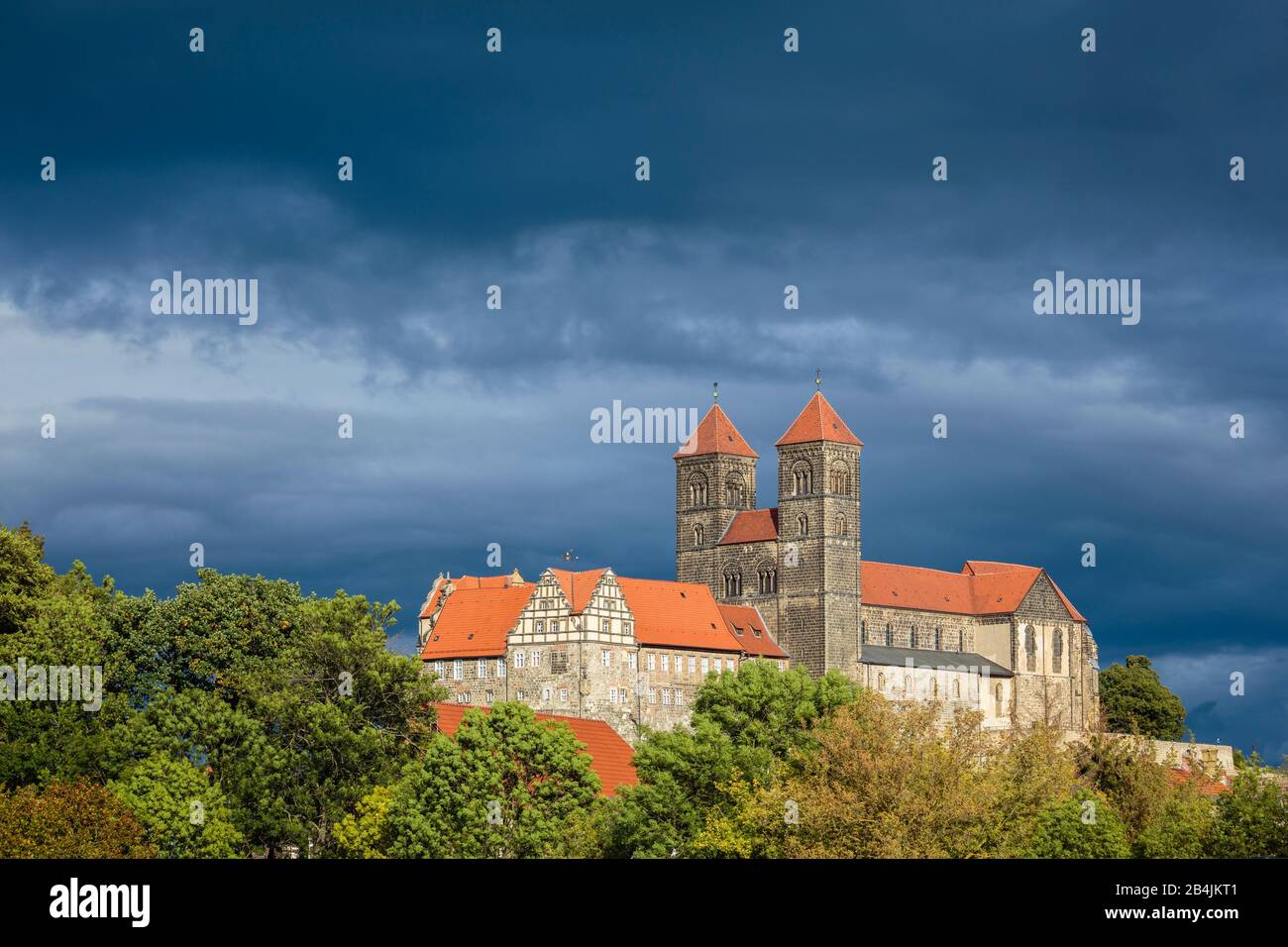 Europa, Deutschland, Sachsen-Anhalt, Quedlinburg. VOR einer Gewitterfront leuchtet der Dom in der Nachmittagssonne. Foto Stock