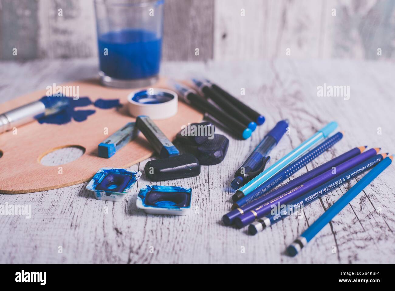 Disposizione di diverse penne e utensili da pittura nel colore blu Foto Stock