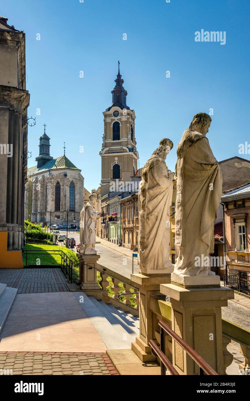 Statue di fronte alla Cattedrale Greco-Cattolica, Cattedrale Cattolica Romana e Campanile in lontananza, a Przemysl, Malopolska, Polonia Foto Stock