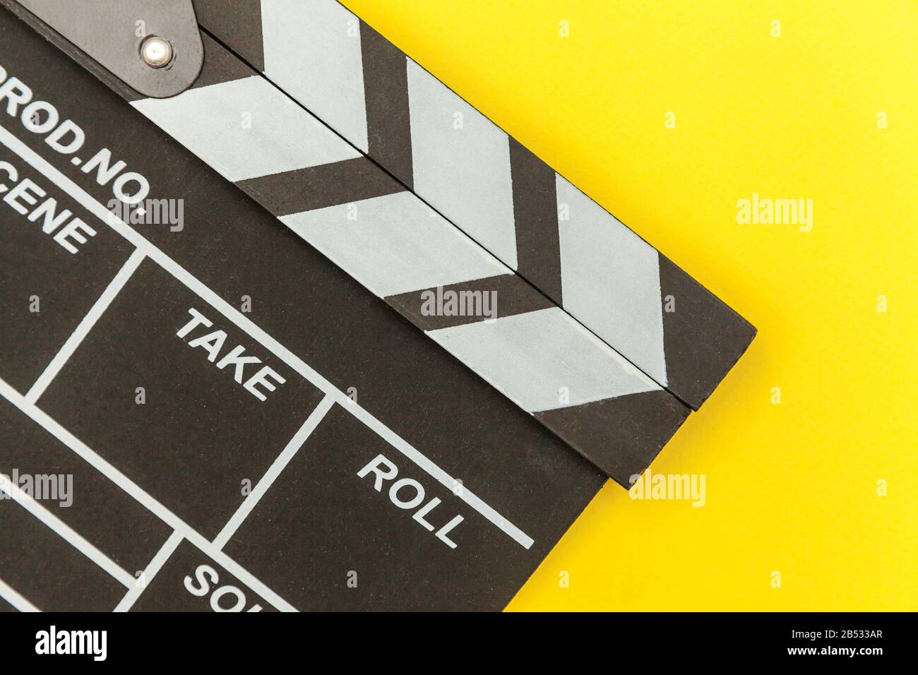 Professione regista. Regista classico film vuoto che rende clapperboard o film ardesia isolato su sfondo giallo. Produzione video cinema indus Foto Stock