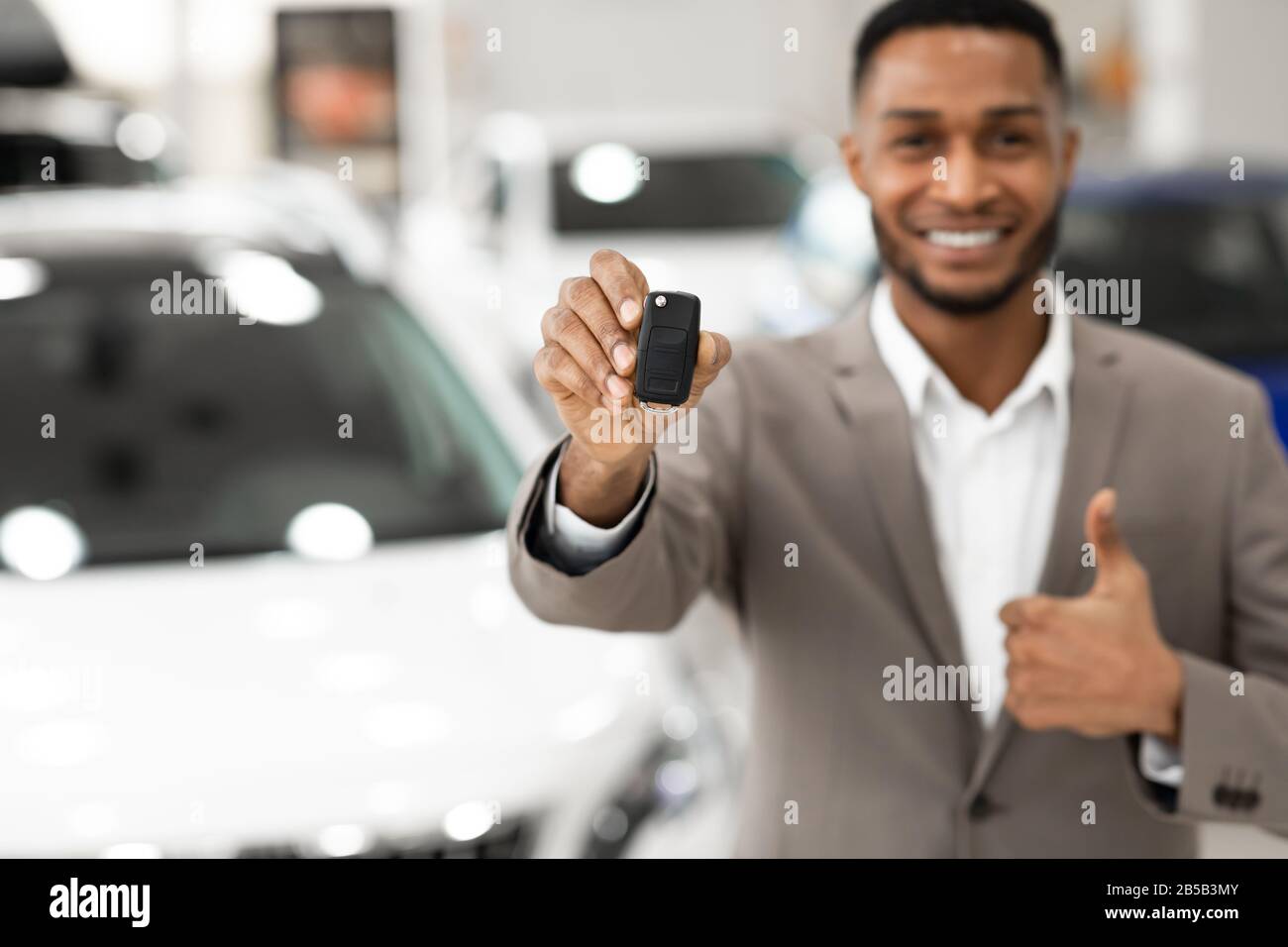 Manager Irriconoscibile Che Mostra Le Thumbs-Up Di Key Gesturing In Store, Profondità Poco Profonda Foto Stock