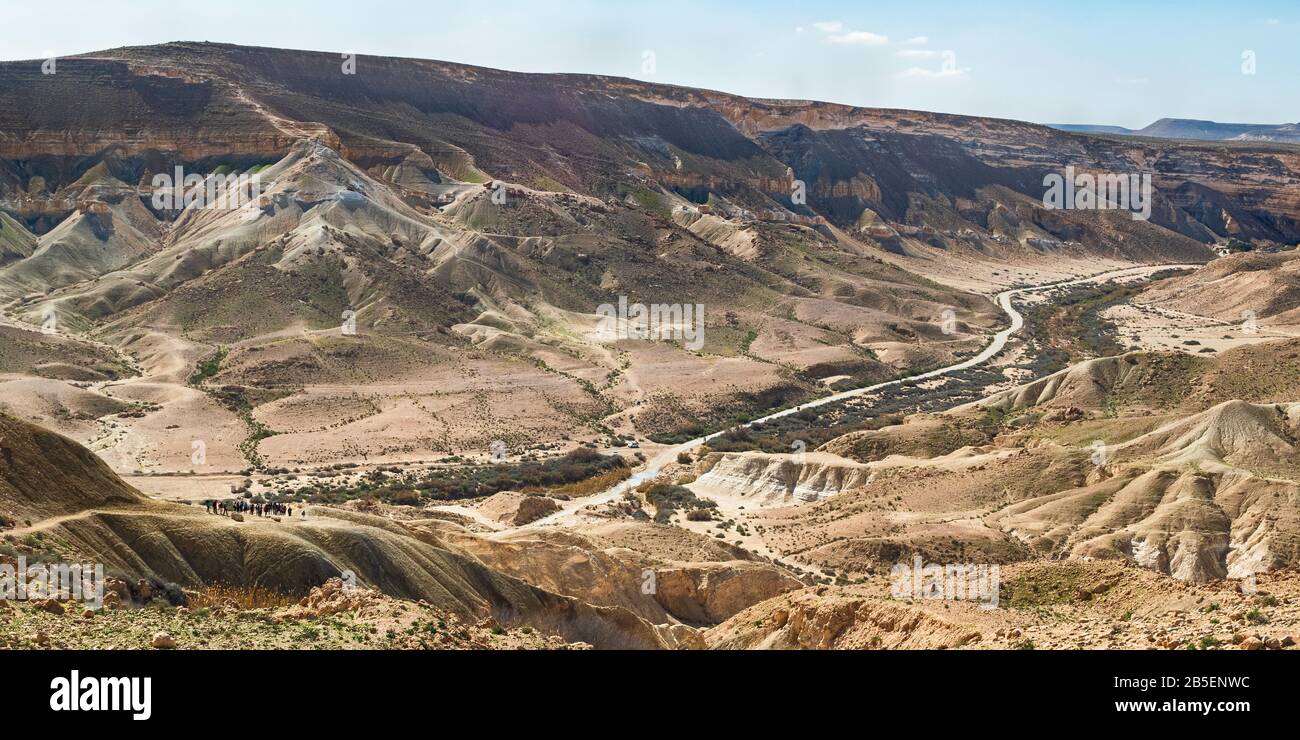 panorama del letto di ruscello di nahal zin, la salita divshon e la strada per ein avdat nel negev in israele con un gruppo lontano di escursionisti nella parte anteriore sinistra Foto Stock