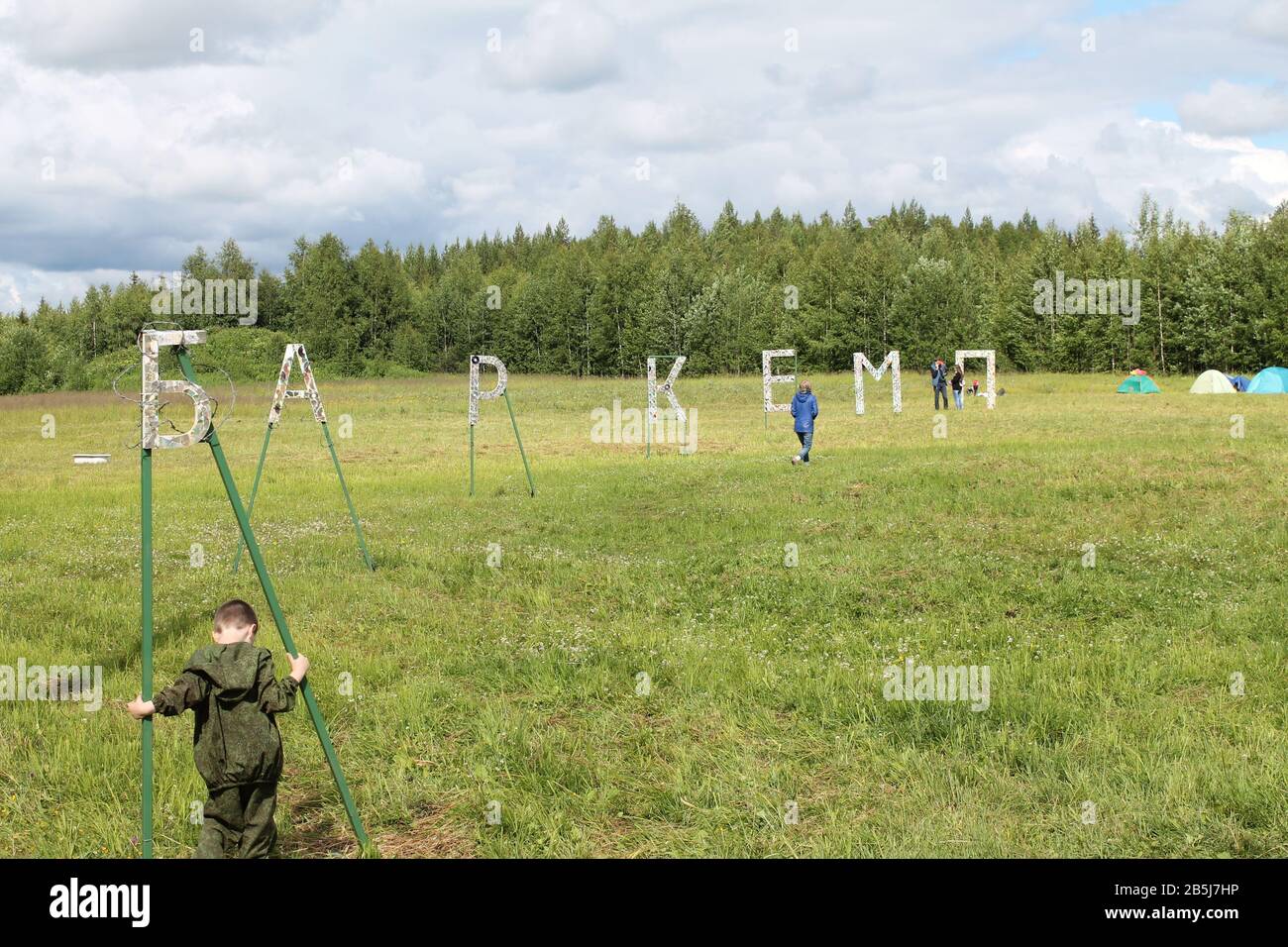 6 Luglio 2019 Syktyvkar, Komi, Russia. Evento annuale di Barcamp. Una conferenza estiva informale con conferenze e discorsi di personalità ed esperti. Vista di un campo con erba verde e un campeggio. Foto Stock