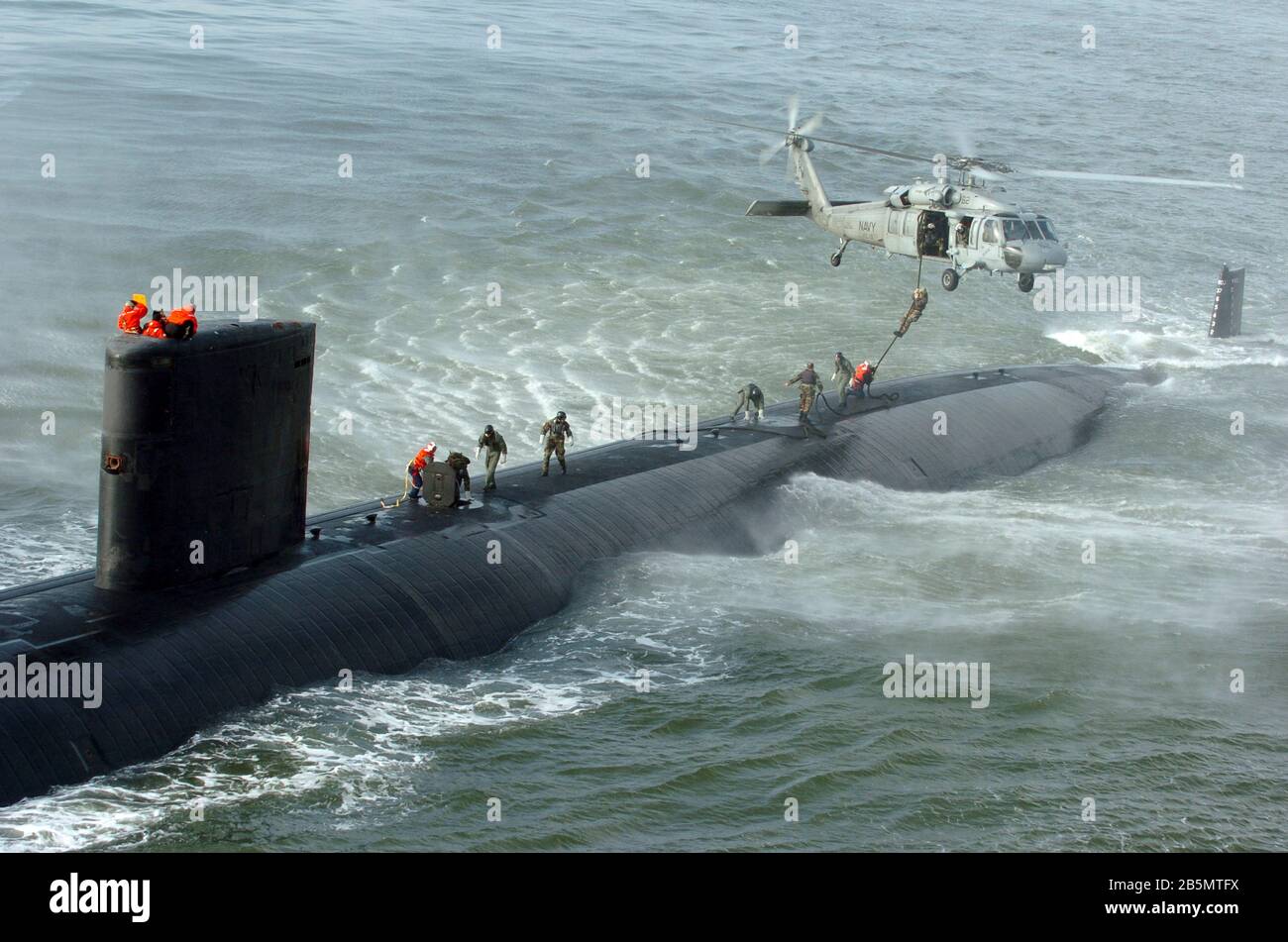 Un team di veicoli per la consegna DELLE FOCHE della marina statunitense svolge un'attività veloce da un elicottero MH-60S Seahawk alla parte superiore del sottomarino di attacco nucleare della classe di Los Angeles USS Toledo in corso nell'Atlantico 17 gennaio 2005 al largo della costa della Georgia. La missione delle squadre SDV comprende l'inserimento clandestino, la consegna degli ordigni, la ricognizione e la localizzazione e il recupero degli oggetti. Foto Stock