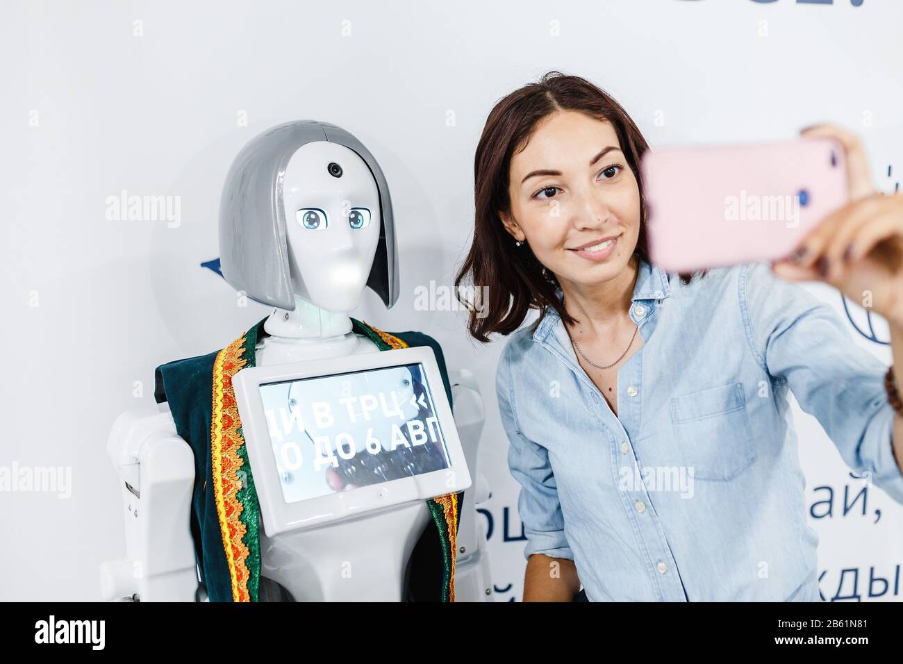 Ultra MALL, UFA, RUSSIA, 21 AGOSTO 2017: Ragazza positiva che fa selfie con robot alla mostra, concetto di istruzione Foto Stock