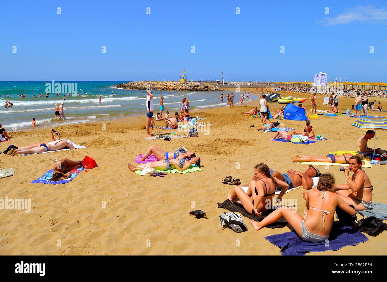 Turisti prendere il sole sulla spiaggia di Gouves a Creta la più grande e più popolata delle isole greche Foto Stock