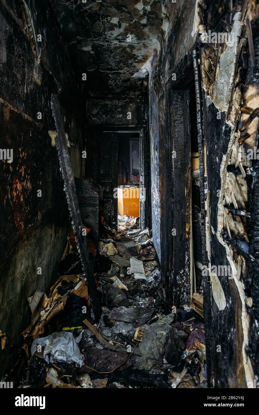 Corridoio di casa di legno bruciato scuro dopo il fuoco. Foto Stock