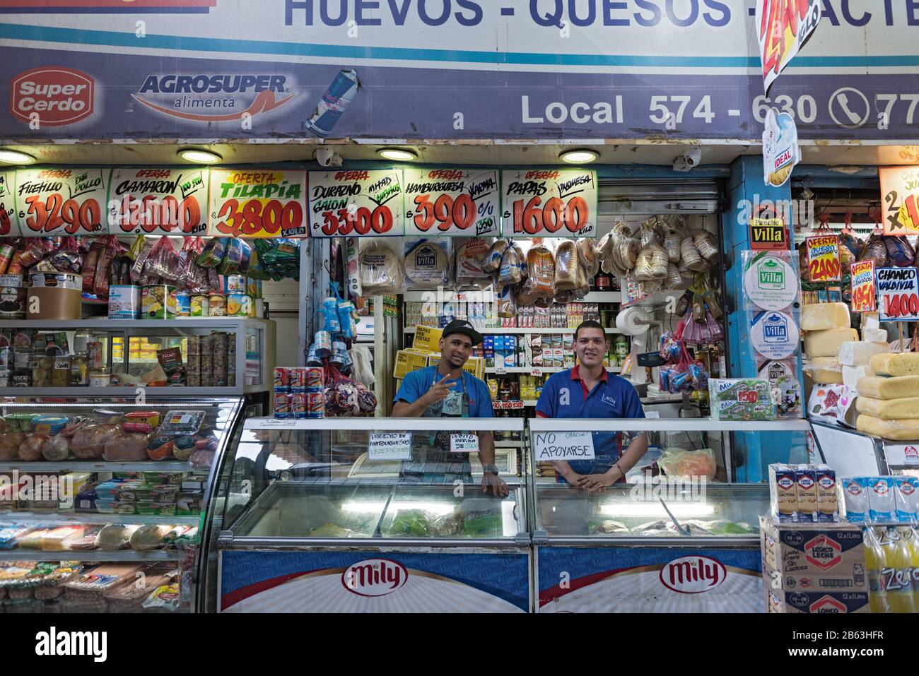 Il venditore vende vari tipi di prodotti a base di carne e formaggio al mercato centrale la Vega di Santiago, Cile Foto Stock