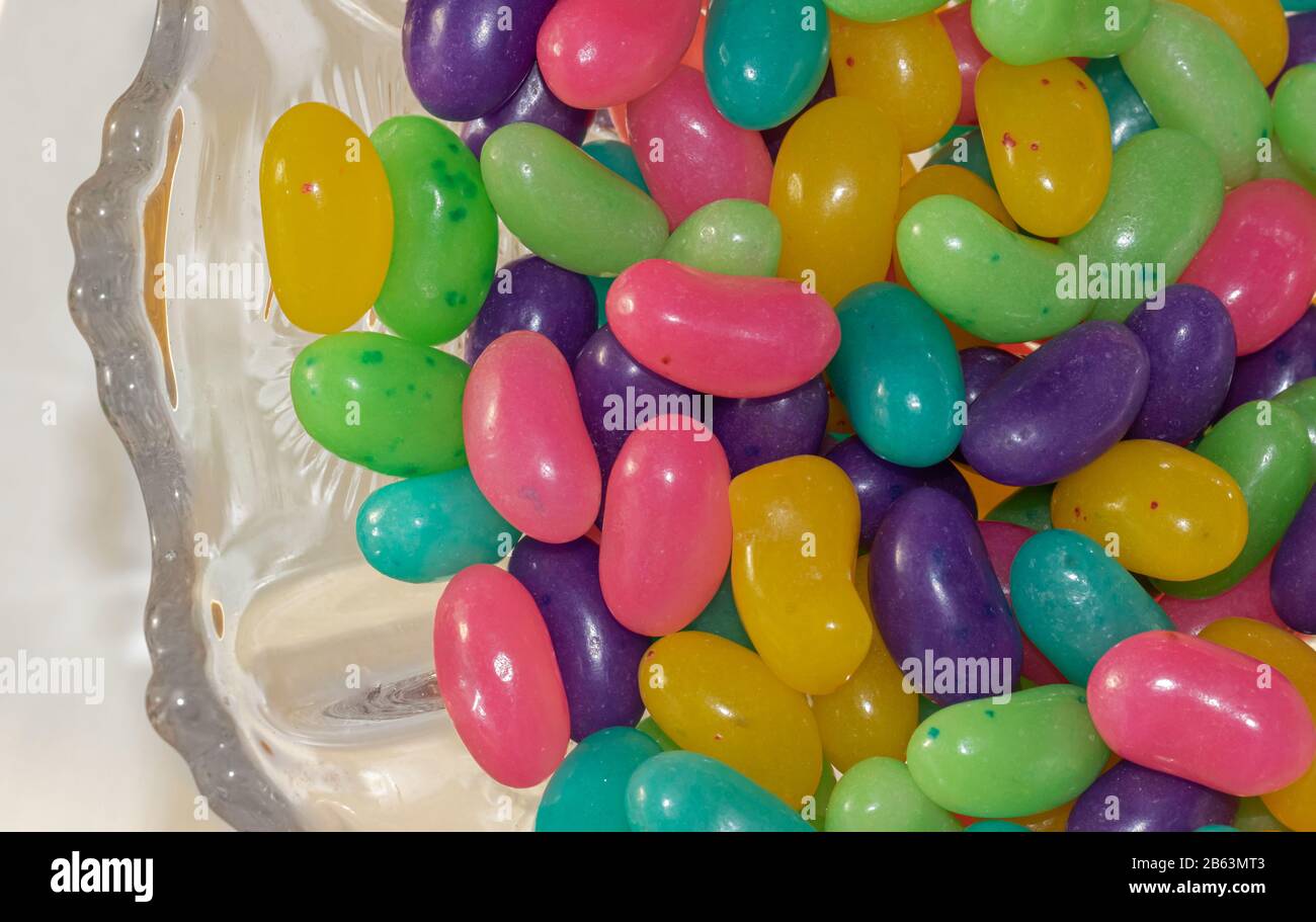 Un antico piatto di caramelle in vetro pieno di caramelle colorate di Pasqua. Foto Stock