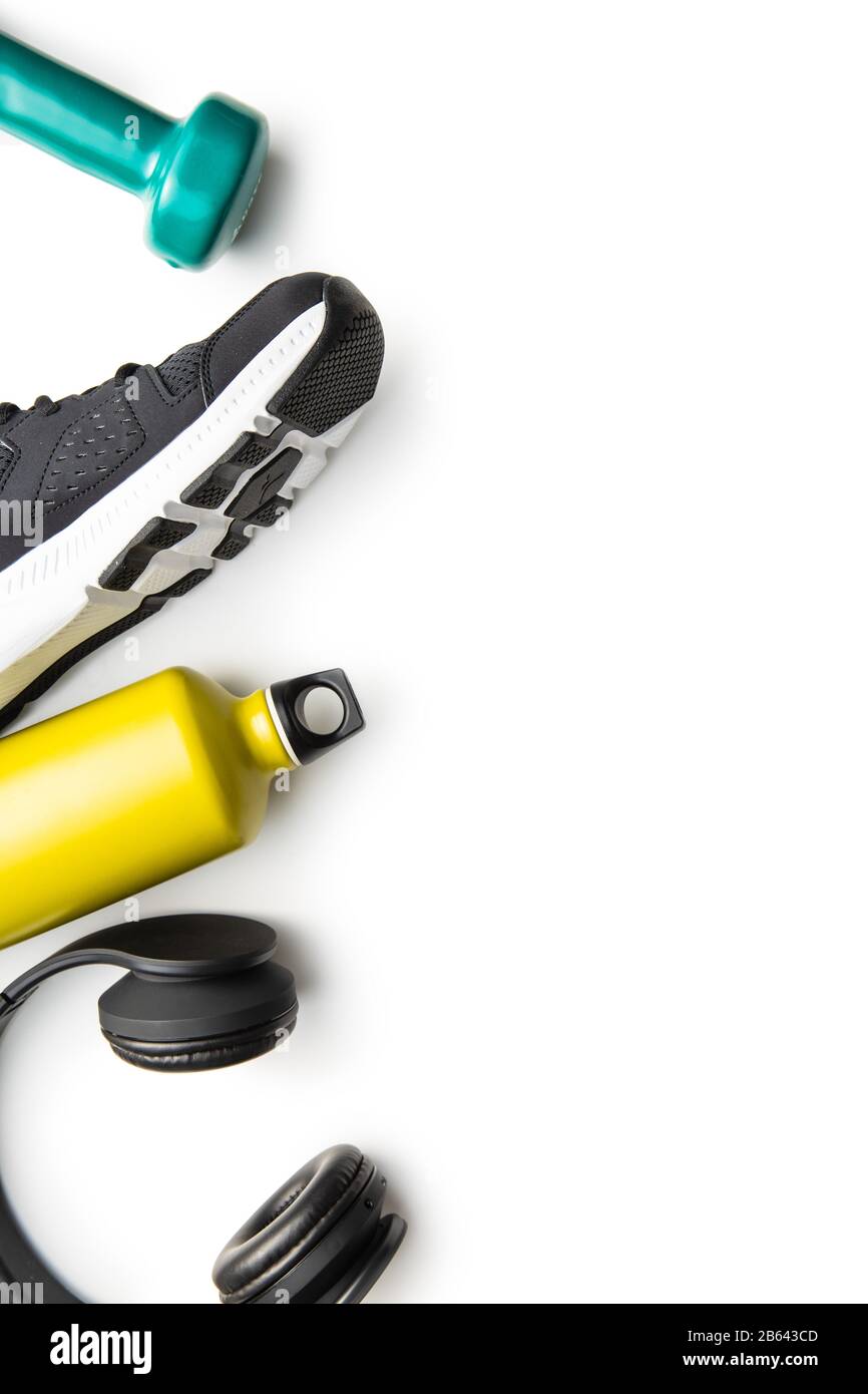 Concetto di fitness. Scarpa sportiva nera, cuffie, manubrio e bottiglia isolati su sfondo bianco. Foto Stock