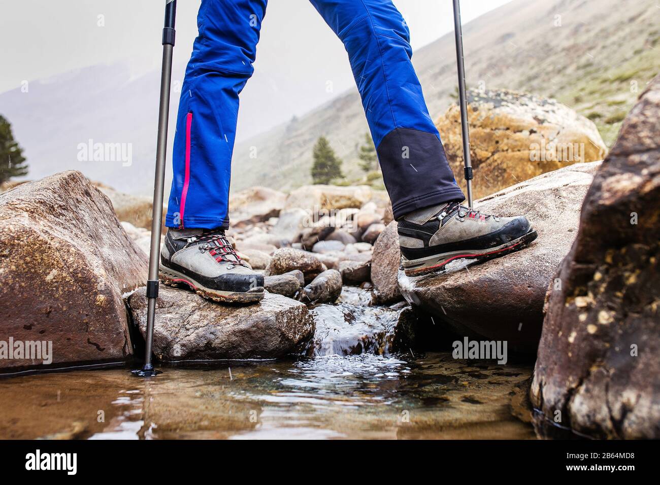 Scarponi da trekking impermeabili guadi un ruscello roccioso di montagna.  Il concetto di attrezzatura da trekking di alta qualità Foto stock - Alamy