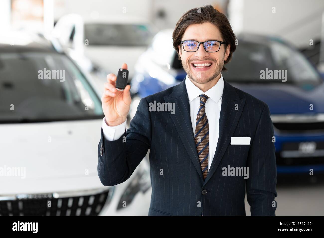 Agente Che Mostra La Chiave Dell'Automobile Nell'Ufficio Di Noleggio Dell'Automobile Foto Stock