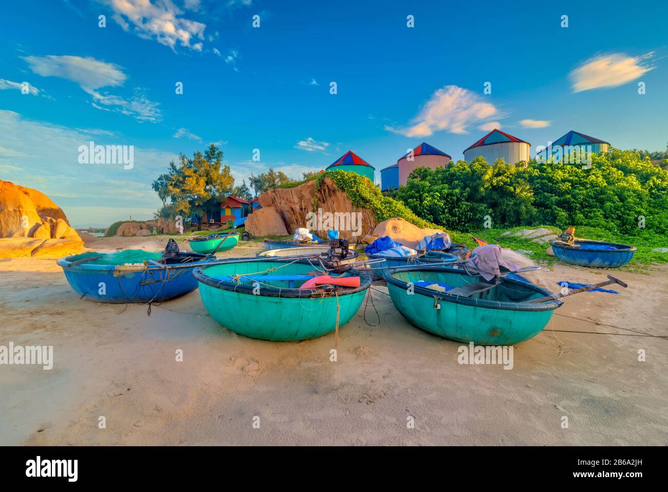 Barche tradizionali accanto al faro di Ke Ga, Binh Thuan, Vietnam. Foto Stock