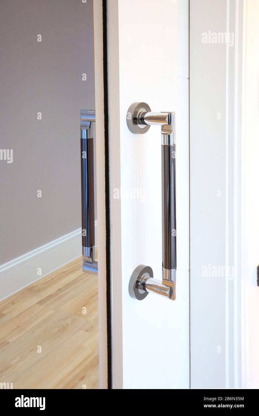 Interno di un appartamento nel Regno Unito che mostra una porta scorrevole tasca che si ritrae nel muro per risparmiare spazio Foto Stock