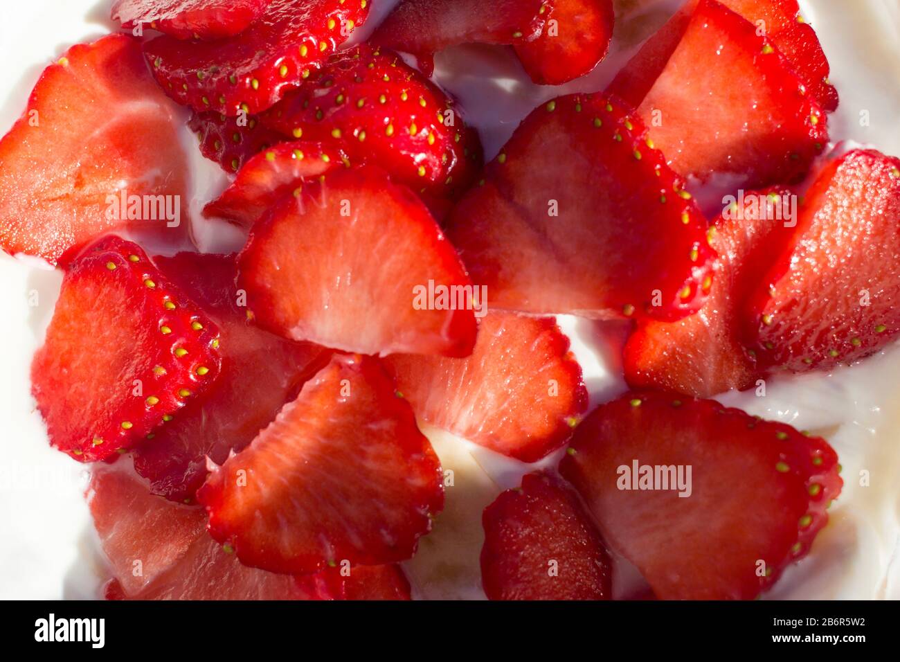 Le fragole tagliate su yogurt greco Foto Stock